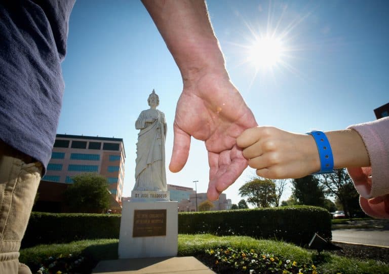 MY SALON Suite Launches 2024 “Suite Relief” Fundraiser To Benefit St. Jude St. Jude Image of child holding adults hand in front of St. Jude Statue
