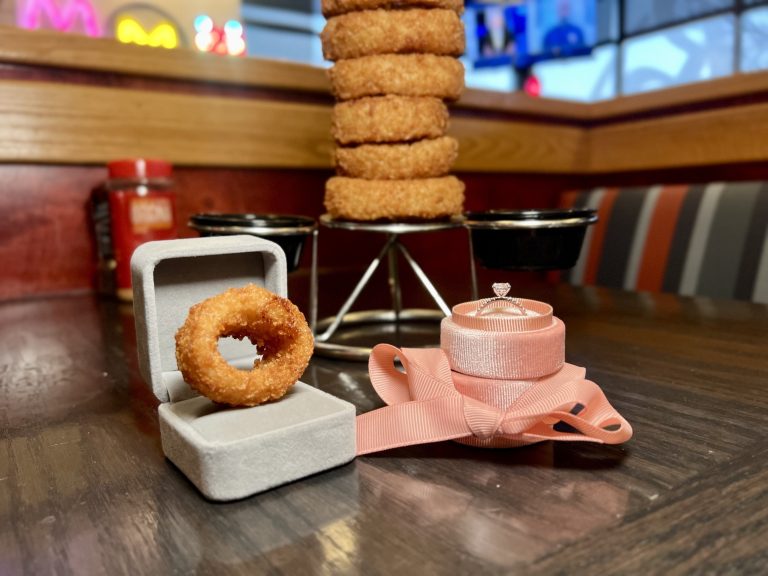 How Red Robin’s Onion Ring Proposal Campaign Could Go Viral This Valentine’s Day Onion ring in engagement ring box at a red robin location.