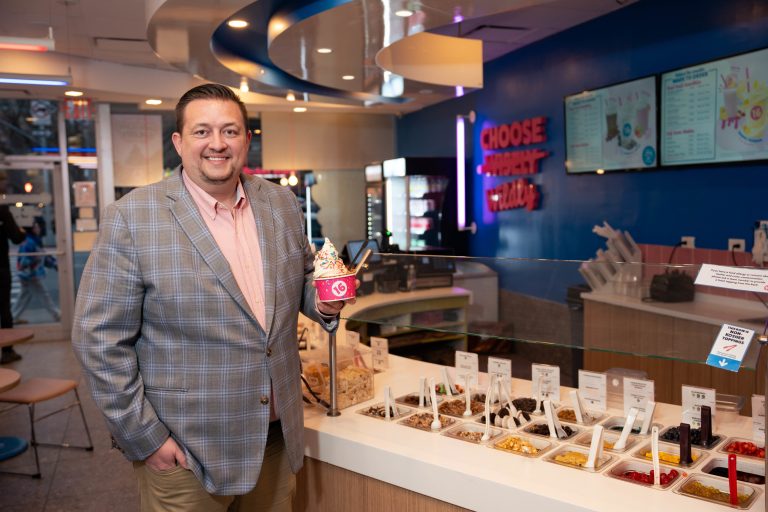 Image of Fred Frey VP of Franchise Development at 16 Handles standing in a location holding a cup of ice cream.