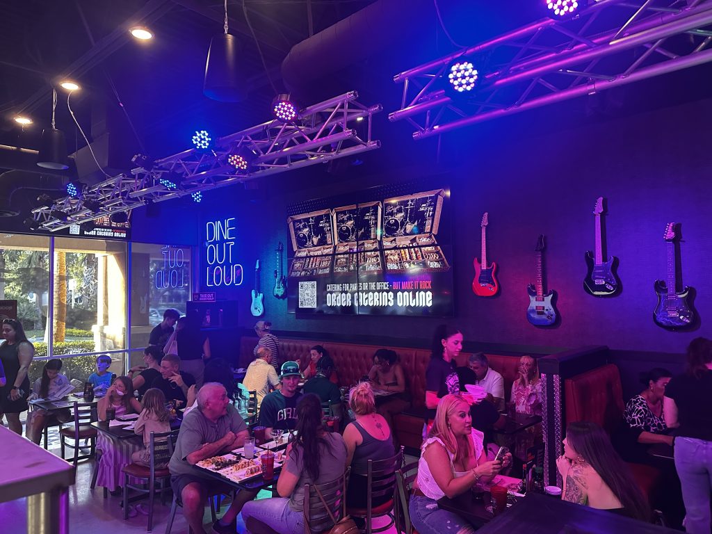 Rock N Roll Sushi Vibes with interior shots of people, music playing and great food