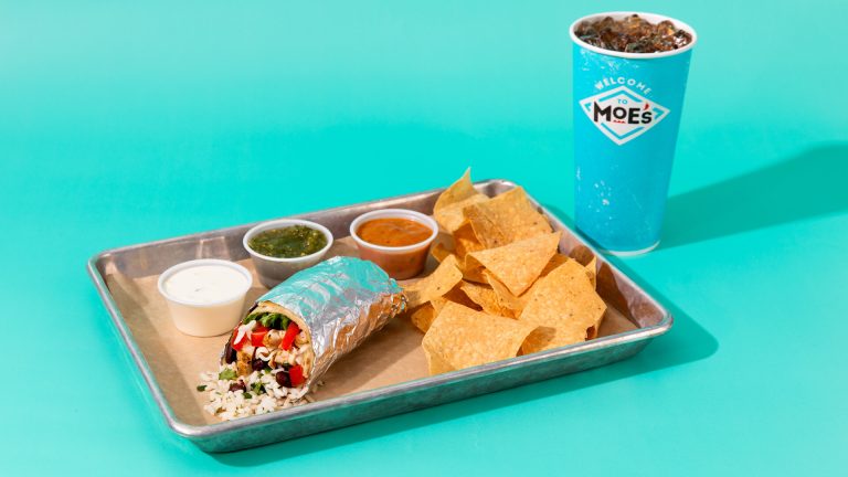 Burrito, chips, and salsa on a tray with a soda in a cup next to it.