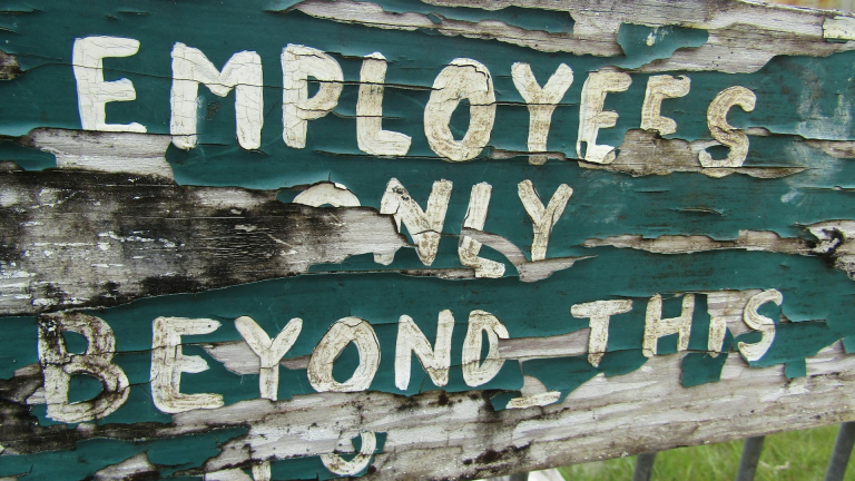 What New Franchisors Need to Know About Joint Employer Risks Image of employee sign on cracked wood and paint