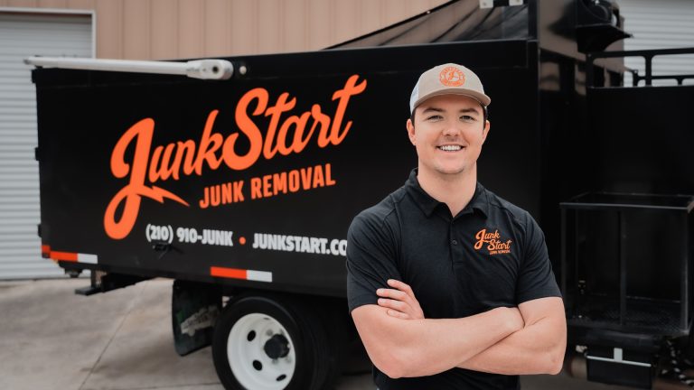 Daniel McCarty, founder of JunkStart Junk Removal, standing in front of a company truck in San Antonio, Texas.
