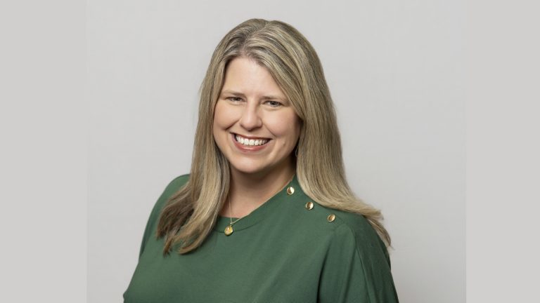 Kate Wright Joins Camp Bow Wow as Vice President of Marketing Smiling woman with long blond hair wearing a green top