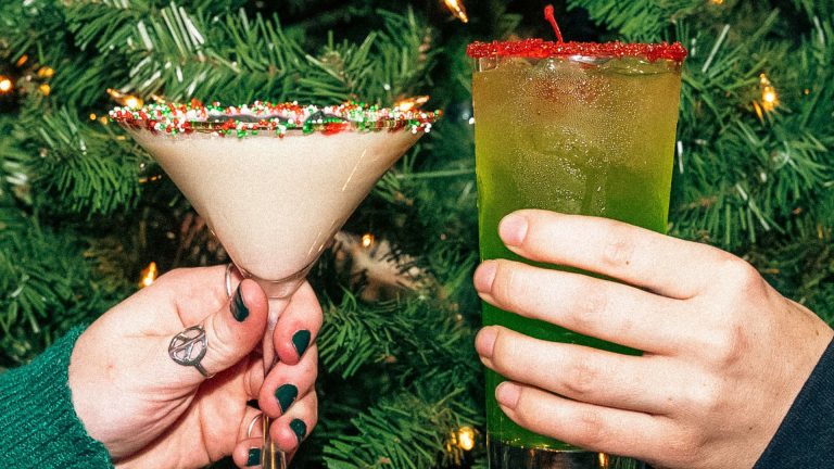 The Greene Turtle Serves Up ‘Tinseltown Toasts’ for the Holidays Two people toast holiday cocktails from The Greene Turtle’s Tinseltown Toasts menu in front of a Christmas tree.