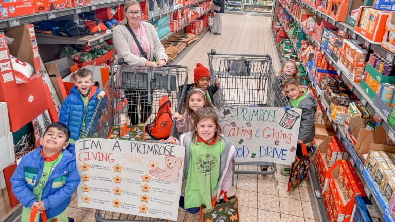Primrose preschoolers and a teacher shop for canned goods during the Caring and Giving Food Drive at a grocery store