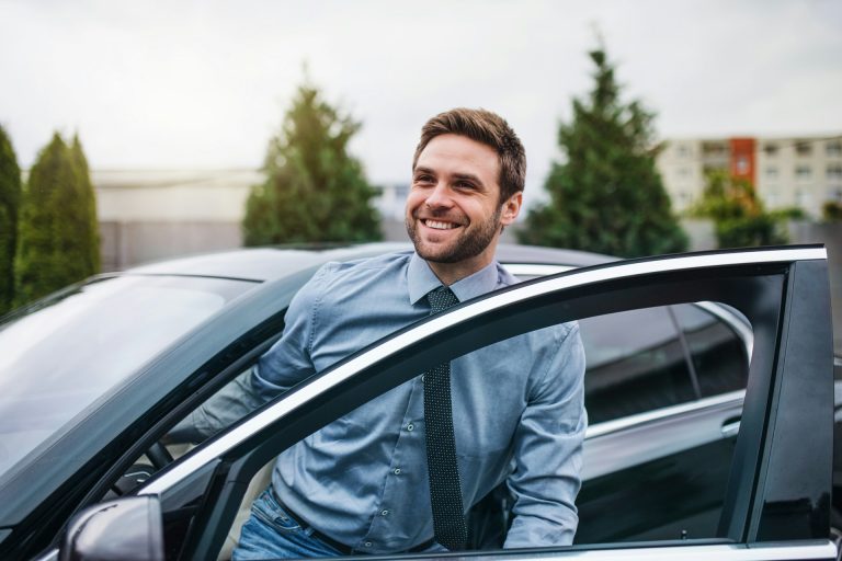 The Puzzle Mindset: How One Manager Turned a Chaotic Holiday Rush Into Customer Loyalty Smiling branch manager stepping out of a car at a rental lot