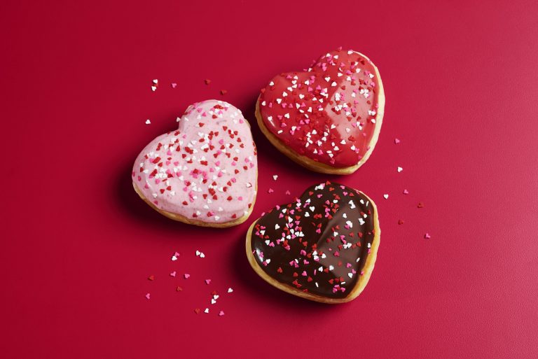 Shipley Do-Nuts Brings Back Heart-Shaped Donuts for Valentine’s Day Three heart-shaped donuts with strawberry, cherry and chocolate icing on red background