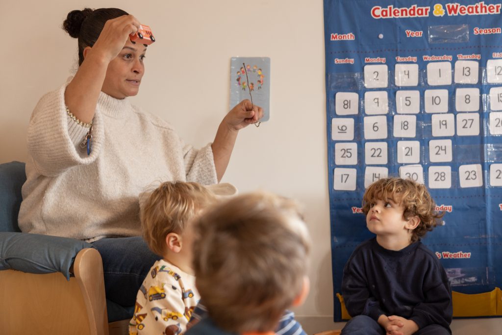 Educator leads a small group lesson with young children at a Haven center