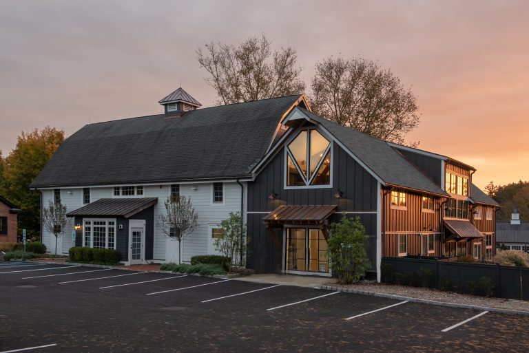 Exterior of a Haven center building at sunset with parking in front