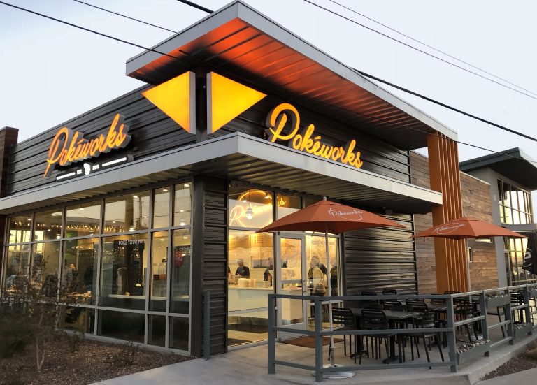 Pokeworks storefront with illuminated signage and patio seating in El Paso