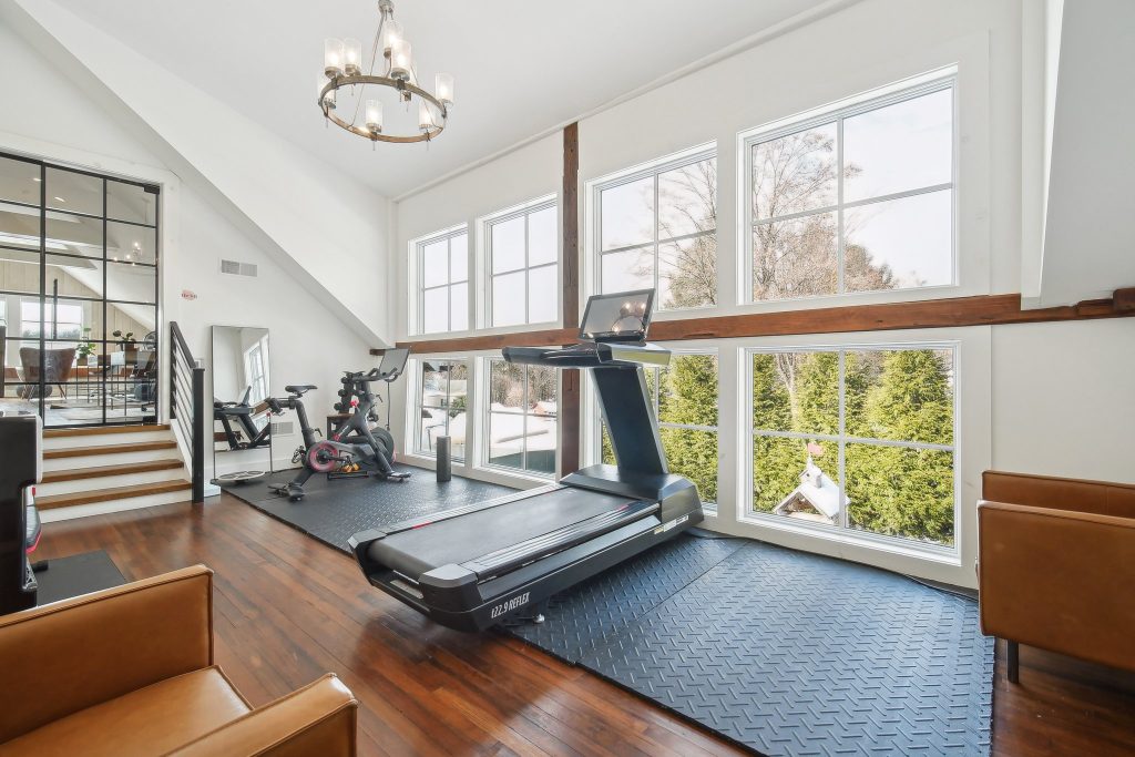 Fitness area at a Haven center with a treadmill, bike, and large windows