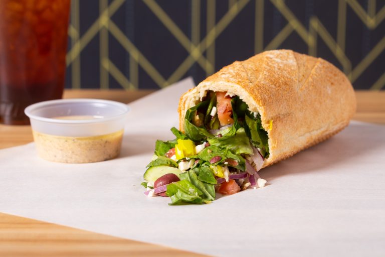 Bread Zeppelin Launches Free Zeppelin Offer After Panera Salad Stuffer Debut Bread Zeppelin signature stuffed baguette filled with fresh chopped salad beside dipping sauce cup