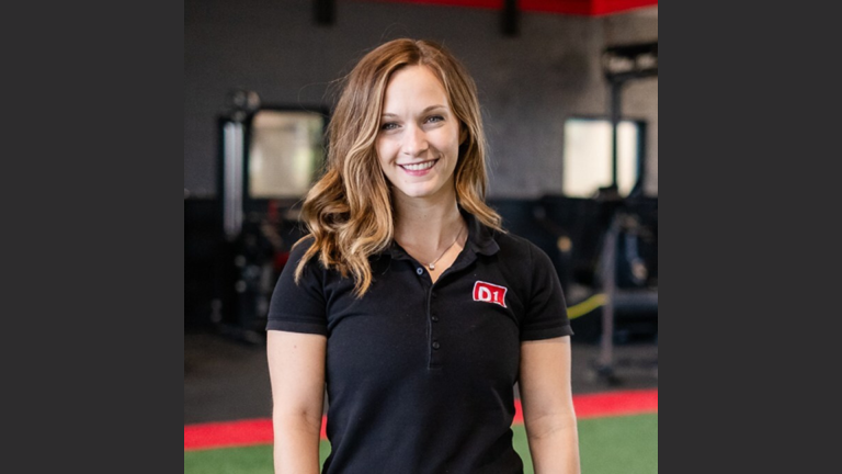 Devon Arnold of D1 Training smiling inside training facility