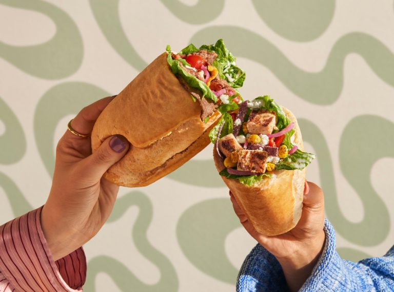 Panera Bread Salad Stuffers Turn a Familiar Strength Into a New Food Innovation Story Two hands hold Panera Salad Stuffers filled with steak and chicken salad ingredients in Italian bread rolls