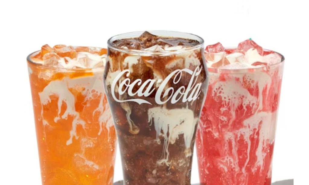 Three Krush’d Sodas with creamy swirls and ice in orange, cola and red flavors