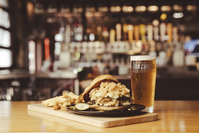 Old Chicago Pizza + Taproom Celebrates 50 Years with Cinco Cero Tour and New Menu Launch Stacked & Smashed Burger with fries and beer at Old Chicago Taproom