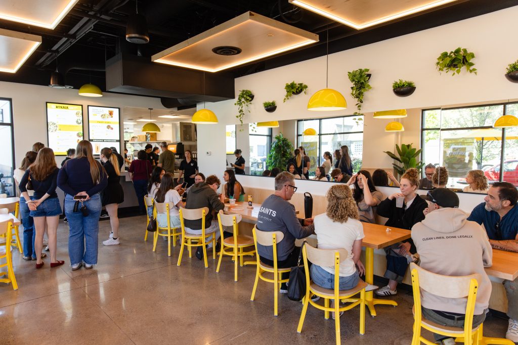 Busy Konala interior dining room filled with customers ordering and seated at tables during peak service
