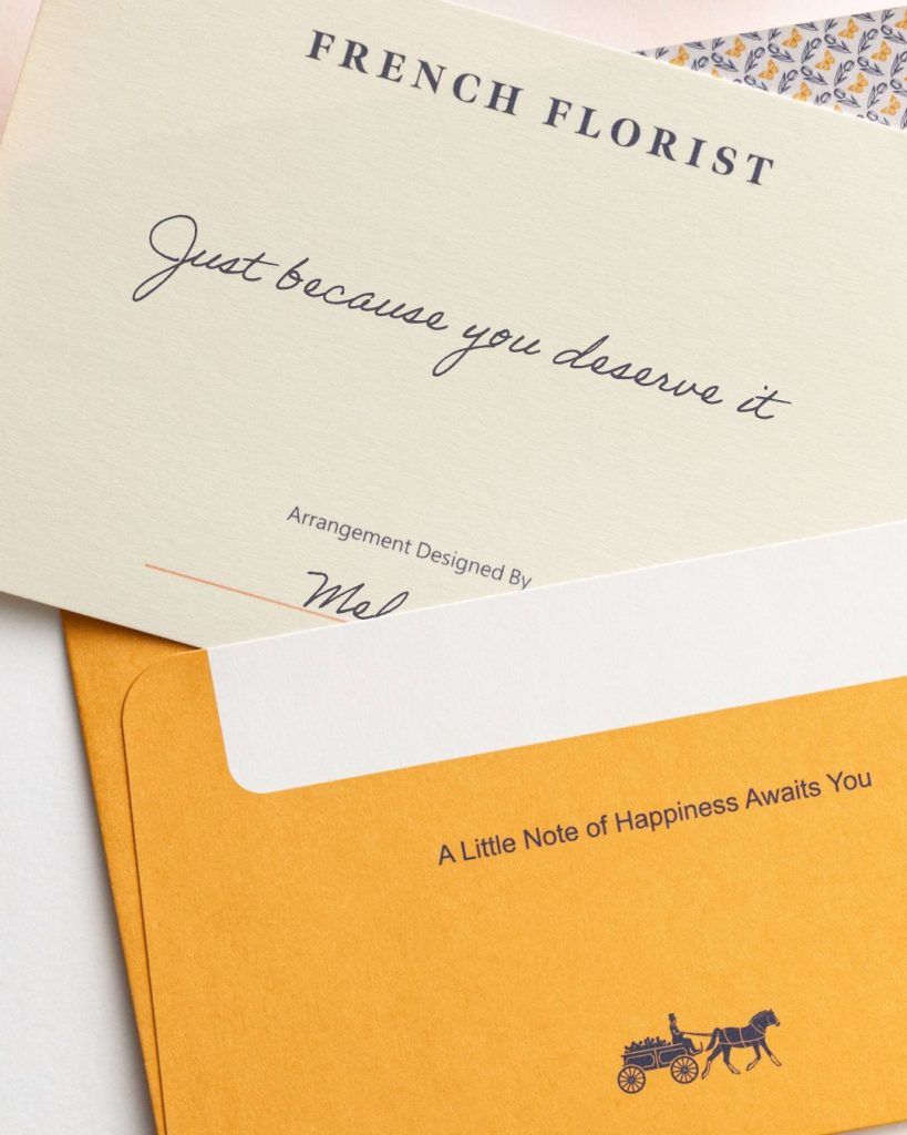 A French Florist branded card reading "Just because you deserve it" with a designer signature and a yellow envelope reading "A Little Note of Happiness Awaits You."