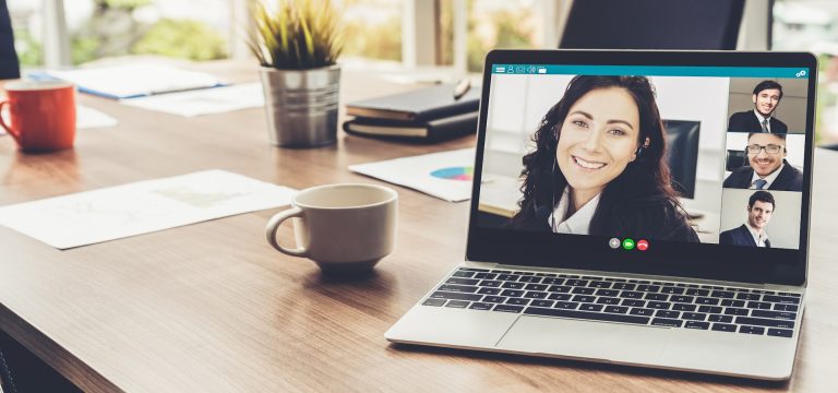 Franchise broker on a video call with remote executive support team displayed on laptop screen