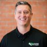 Nate Tew, guest writer for Franchise Brief, headshot in Keyrenter Property Management shirt