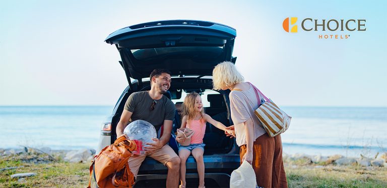 Family unpacking a car near the water for a Choice Hotels road trip campaign