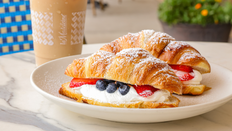 la Madeleine Celebrates World Cup Wins With Free Croissants and a New Pastry la Madeleine Red, White & Blue Croissant with iced coffee on café patio