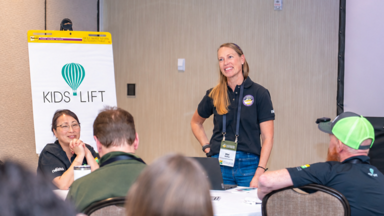 Vivi Nellen, Executive Director of Kids Lift, speaking with Premium Service Brands franchise owners at a company conference