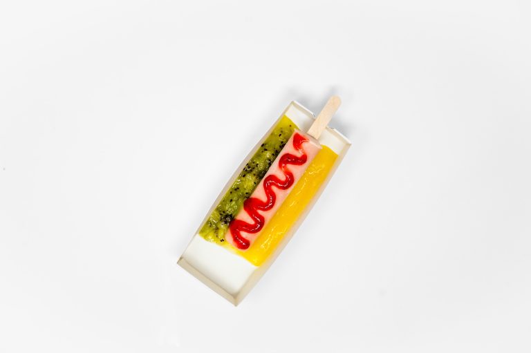 Tropical Smoothie Cafe Smoothie Dog with strawberry, pineapple and kiwi toppings