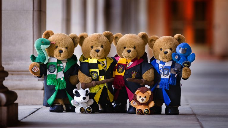 Build-A-Bear Expands Harry Potter Collection With New Plush and Fan Giveaway Build-A-Bear Harry Potter bears wearing Hogwarts House robes and scarves with House mascot Mini Beans