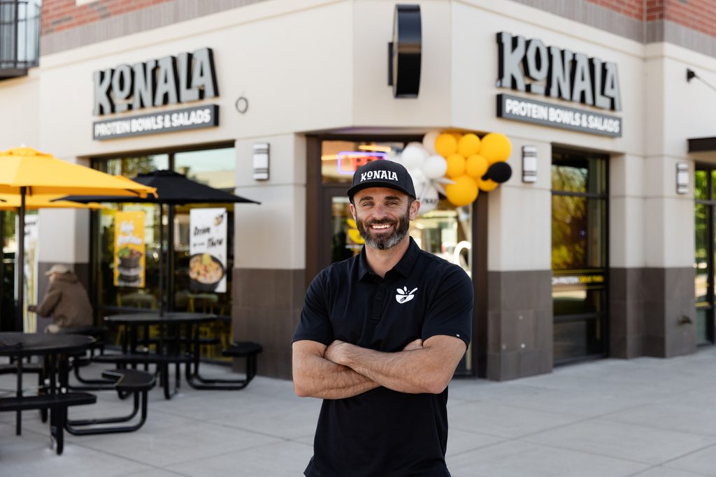 Konala founder Trace Miller stands outside a Konala Protein Bowls & Salads storefront.