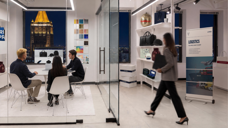 Beyond the Logo: How LR Paris Turns Brand Essence Into Products Worth Keeping LR Paris team meeting in a branded-products showroom featuring merchandise, packaging and logistics displays.