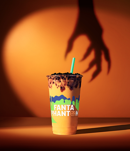 Tropical Smoothie Cafe and Fanta Show the Power of Seasonal Collaborations Fanta Phantom Smoothie from Tropical Smoothie Cafe with a green straw and spooky Halloween shadow in the background